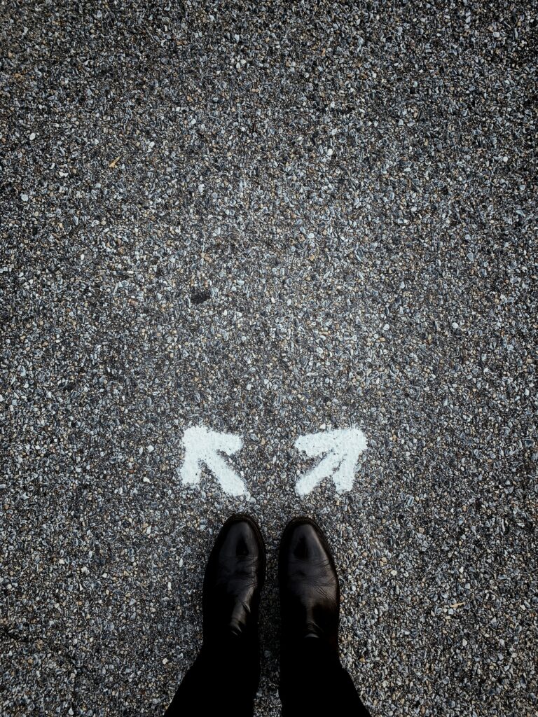 Man thinking of which of the 2 directions to take